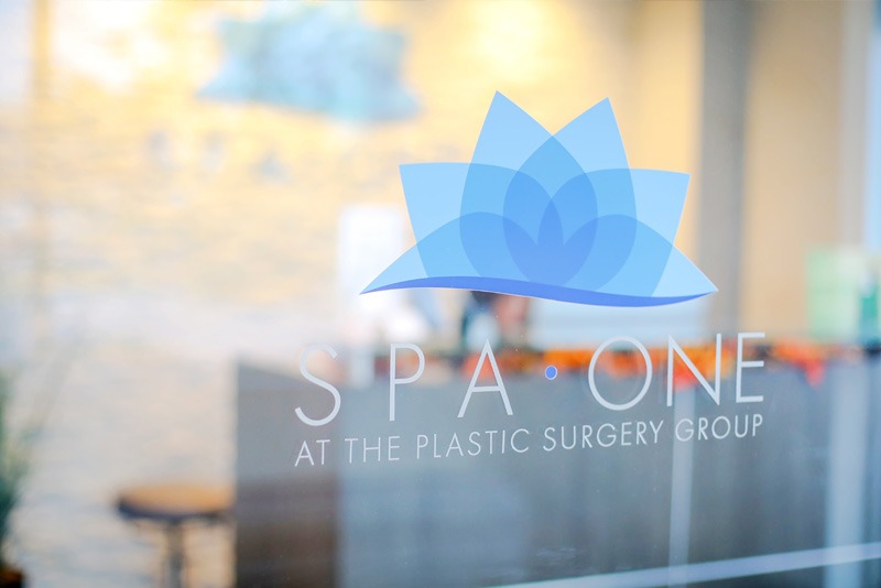 Photograph of Spa One at The Plastic Surgery Group logo on glass window